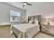 Comfortable bedroom featuring a soft, inviting bed, bedside lamps, a ceiling fan, and a window that lets in natural light at 19624 Lonesome Pine Dr, Land O Lakes, FL 34638