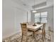 Dining room with neutral decor, modern light fixture, and area rug over tile floors at 19624 Lonesome Pine Dr, Land O Lakes, FL 34638