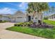 Inviting single-story home boasts lush landscaping, a paver driveway, and well-manicured lawn at 19624 Lonesome Pine Dr, Land O Lakes, FL 34638