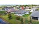 Well-maintained single-story home featuring a gray roof, neutral paint, green lawn, and lush landscaping at 19624 Lonesome Pine Dr, Land O Lakes, FL 34638