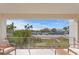 A relaxing balcony with stunning view of beach, palm trees and bright blue sky at 2003 Gulf Way, St Pete Beach, FL 33706