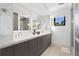 Modern bathroom with double vanity, sleek mirrors, and a large window at 2003 Gulf Way, St Pete Beach, FL 33706