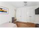 Bright bedroom with wood floors, neutral walls, and minimal decorations at 2003 Gulf Way, St Pete Beach, FL 33706