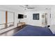Spacious bedroom with dark wood floors, large window, and ceiling fan at 2003 Gulf Way, St Pete Beach, FL 33706