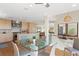 Open concept dining area connected to the kitchen with a glass table and modern lighting at 2003 Gulf Way, St Pete Beach, FL 33706