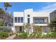Contemporary two-story home featuring a modern architectural design and well-maintained landscaping at 2003 Gulf Way, St Pete Beach, FL 33706