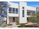 Modern home showcasing a paved walkway leading to the front entrance, complemented by minimalist landscaping at 2003 Gulf Way, St Pete Beach, FL 33706