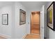 Hallway featuring an elevator with light wood paneling and modern artwork at 2003 Gulf Way, St Pete Beach, FL 33706