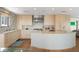 Spacious kitchen featuring modern appliances, light wood cabinets, and a large island at 2003 Gulf Way, St Pete Beach, FL 33706