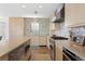 Modern kitchen featuring updated cabinets, stainless steel appliances, and tile backsplash at 2003 Gulf Way, St Pete Beach, FL 33706