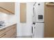 Laundry room features stacked washer and dryer with modern cabinets and countertops at 2003 Gulf Way, St Pete Beach, FL 33706
