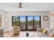 Bright living room featuring hardwood floors and sliding glass doors opening to ocean view at 2003 Gulf Way, St Pete Beach, FL 33706