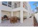 Outdoor seating area features grill, barstools, and comfortable couch with decorative pillows at 2003 Gulf Way, St Pete Beach, FL 33706