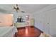 Bedroom featuring hardwood floors, ceiling fan, and ensuite bathroom at 2202 Clubhouse Dr # 174, Sun City Center, FL 33573