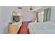 Bedroom featuring hardwood floors, an accent chair, and a sliding door to an enclosed porch at 2202 Clubhouse Dr # 174, Sun City Center, FL 33573