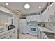 Functional kitchen with white appliances and ample counter space adjacent to the breakfast nook at 2202 Clubhouse Dr # 174, Sun City Center, FL 33573