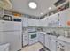Well-lit kitchen with all-white cabinetry and a sleek design for a clean, minimalist look at 2202 Clubhouse Dr # 174, Sun City Center, FL 33573