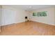 Bedroom with a ceiling fan, laminate floor, closet doors, and a window at 2229 Americus W Blvd # 25, Clearwater, FL 33763