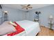 Bedroom featuring a ceiling fan, wood floor, and closet space at 2229 Americus W Blvd # 25, Clearwater, FL 33763