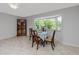 A well-lit dining room featuring neutral paint and ceramic tile flooring at 2229 Americus W Blvd # 25, Clearwater, FL 33763