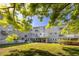 Multi-story building with grey exterior and balconies surrounded by lush trees at 2229 Americus W Blvd # 25, Clearwater, FL 33763