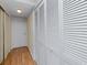Hallway with laminate flooring and access to multiple closets at 2229 Americus W Blvd # 25, Clearwater, FL 33763
