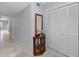 Hallway with ceramic tile flooring, coat closet and mirrored table at 2229 Americus W Blvd # 25, Clearwater, FL 33763