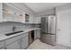 Kitchen featuring stainless steel appliances, grey cabinets, and updated sink at 2229 Americus W Blvd # 25, Clearwater, FL 33763