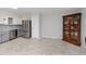 Kitchen featuring stainless steel refrigerator, white cabinets, and tile floors at 2229 Americus W Blvd # 25, Clearwater, FL 33763
