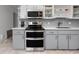 Close up of kitchen with stainless steel double oven and modern finishes at 2229 Americus W Blvd # 25, Clearwater, FL 33763