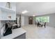 Open kitchen and dining area with stainless steel appliances, tile backsplash, and large bay window with natural light at 2229 Americus W Blvd # 25, Clearwater, FL 33763
