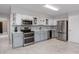 Updated kitchen features stainless appliances, gray cabinets, tile floors, and a full suite of modern amenities at 2229 Americus W Blvd # 25, Clearwater, FL 33763