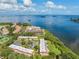 Aerial view of waterfront condos with mature trees at 2700 Bayshore Blvd # 532, Dunedin, FL 34698