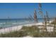 A serene beach view with pristine white sand and gentle waves under a clear blue sky at 2700 Bayshore Blvd # 532, Dunedin, FL 34698
