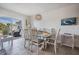Cozy dining area with a stylish chandelier, a sliding glass door, and coastal accents at 2700 Bayshore Blvd # 532, Dunedin, FL 34698