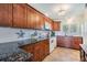 Updated kitchen featuring granite countertops, wood cabinetry, and modern appliances at 2700 Bayshore Blvd # 532, Dunedin, FL 34698