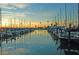 Scenic marina view at sunset, showcasing sailboats docked in the calm water with golden reflections at 2700 Bayshore Blvd # 532, Dunedin, FL 34698
