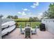 Outdoor seating area with table, chairs, grill and kayaks at 2700 Bayshore Blvd # 532, Dunedin, FL 34698