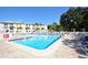 Large community pool with lounge chairs surrounded by mature landscaping at 2700 Bayshore Blvd # 532, Dunedin, FL 34698