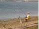 A person sits on a beach chair and is fishing in the water at 2700 Bayshore Blvd # 532, Dunedin, FL 34698