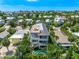 Aerial view of a multi-story home with a rooftop deck, balconies, and swimming pool at 311 Spring Ave, Anna Maria, FL 34216