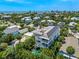 A high angle aerial shot showcases a multi-story home with a rooftop deck and private pool near the coast at 311 Spring Ave, Anna Maria, FL 34216