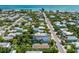 An aerial shot shows a beach community and the subject property's location near the coastline at 311 Spring Ave, Anna Maria, FL 34216