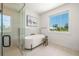 Bright bathroom with soaking tub, glass shower and large window providing natural light at 311 Spring Ave, Anna Maria, FL 34216
