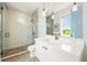 Modern bathroom featuring a glass shower, dual vanity with sleek countertops, and stylish fixtures at 311 Spring Ave, Anna Maria, FL 34216