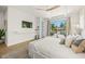 Relaxing bedroom with balcony, large window, and ceiling fan, perfect for tranquil living at 311 Spring Ave, Anna Maria, FL 34216