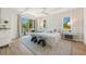 Light-filled bedroom features balcony access and neutral decor for a relaxing retreat at 311 Spring Ave, Anna Maria, FL 34216