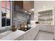 Bright kitchen features modern appliances, white cabinets, and a stylish tile backsplash, offering both beauty and functionality at 311 Spring Ave, Anna Maria, FL 34216