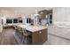 Bright and spacious kitchen with a large island, modern appliances, and stylish decor at 311 Spring Ave, Anna Maria, FL 34216