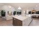 Modern kitchen with an island, countertop seating, stainless steel appliances, and natural lighting at 311 Spring Ave, Anna Maria, FL 34216